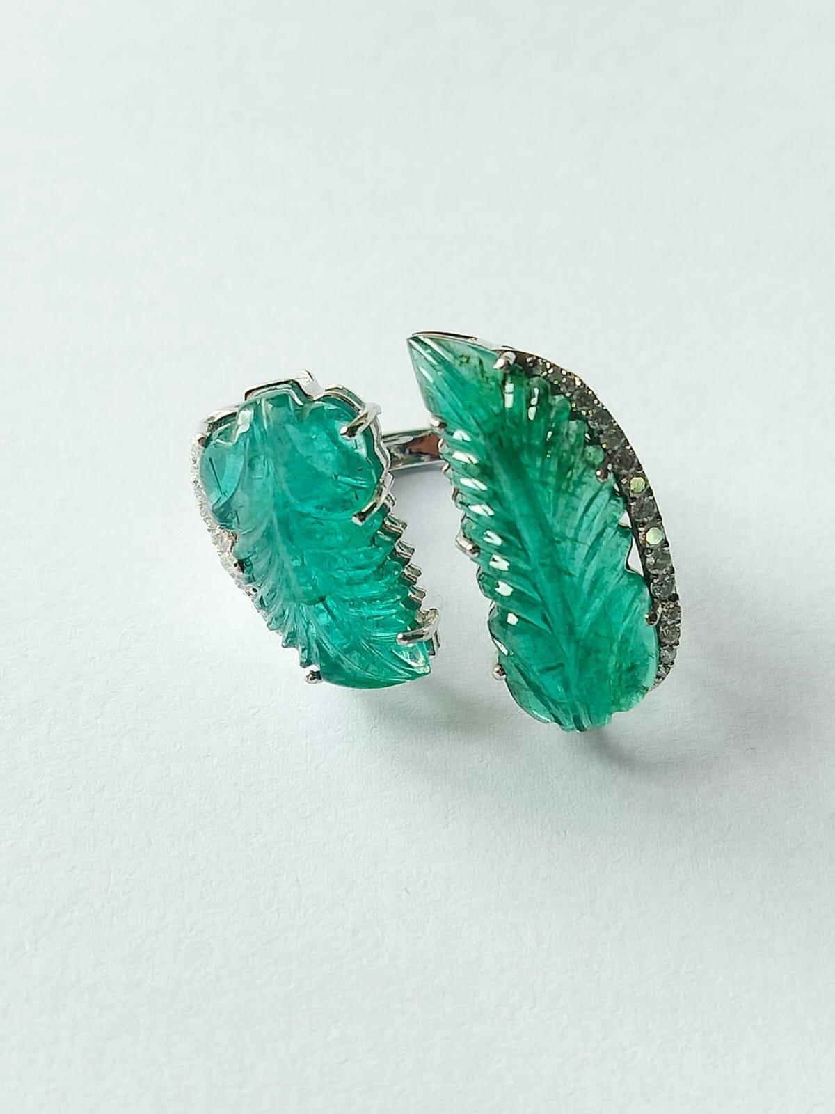 A classic Art Deco style Emerald Cocktail ring set in 18K Gold & Diamonds. The weight of the Emeralds is 17.14 carat. The Emeralds are completely natural, without any treatment and is of Zambian origin. The Emeralds are hand - carved in our very own