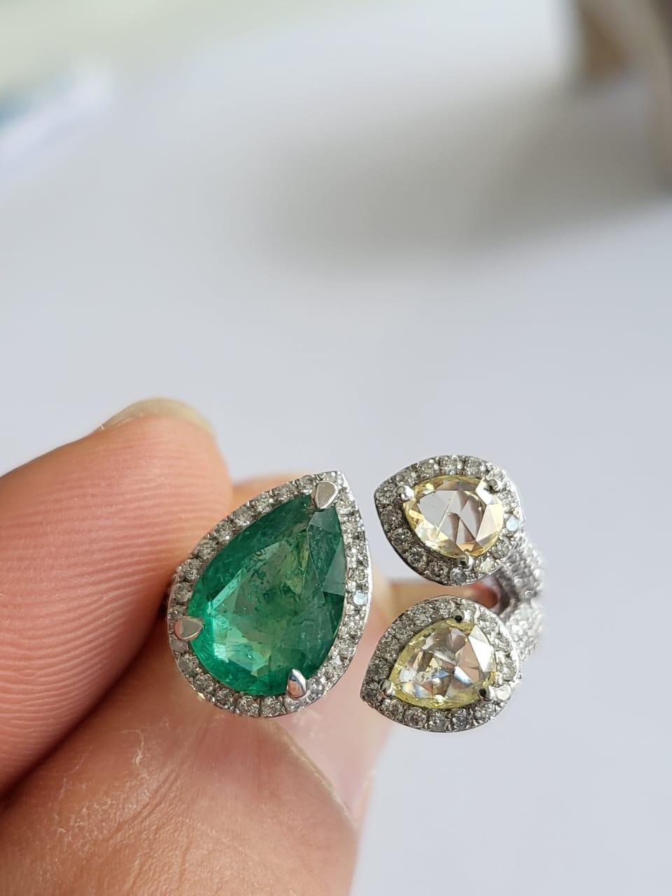 A very beautiful and modern, Emerald Engagement Wedding Ring set in 18K White Gold & Diamonds. The weight of the pear shaped Emerald is 1.72 carats. The Emerald is completely natural, without any treatment and is of Zambian origin. The combined