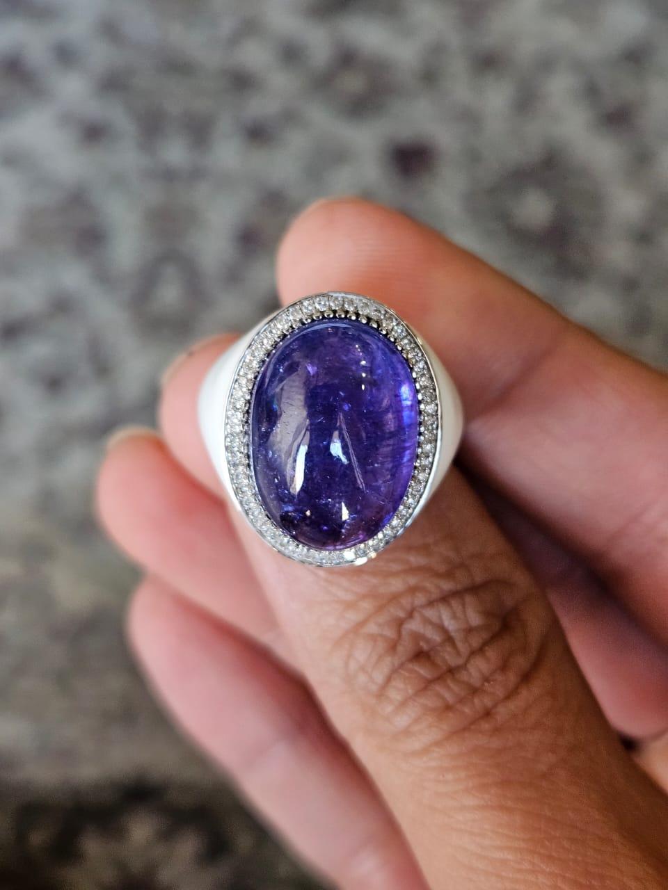A very beautiful and vintage style, Tanzanite & White Enamel Cocktail Dome Ring set in 18K White Gold & Diamonds. The weight of the Tanzanite Cabochon is 17.39 carats. The Tanzanite is responsibly sourced from Tanzania. The Diamonds weight is 0.26