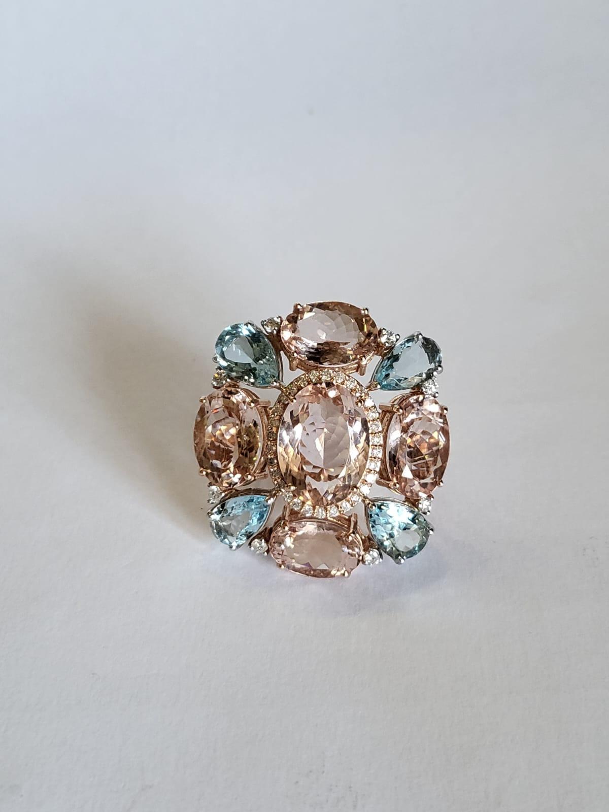 A very gorgeous and one of a kind, Aquamarine & Morganite Cocktail Ring set in 18K Rose Gold & Diamonds. The weight of the Oval shaped Morganites is 18.67 carats. The weight of the Pear shaped Aquamarines is 4.59 carats. The weight of the Diamonds