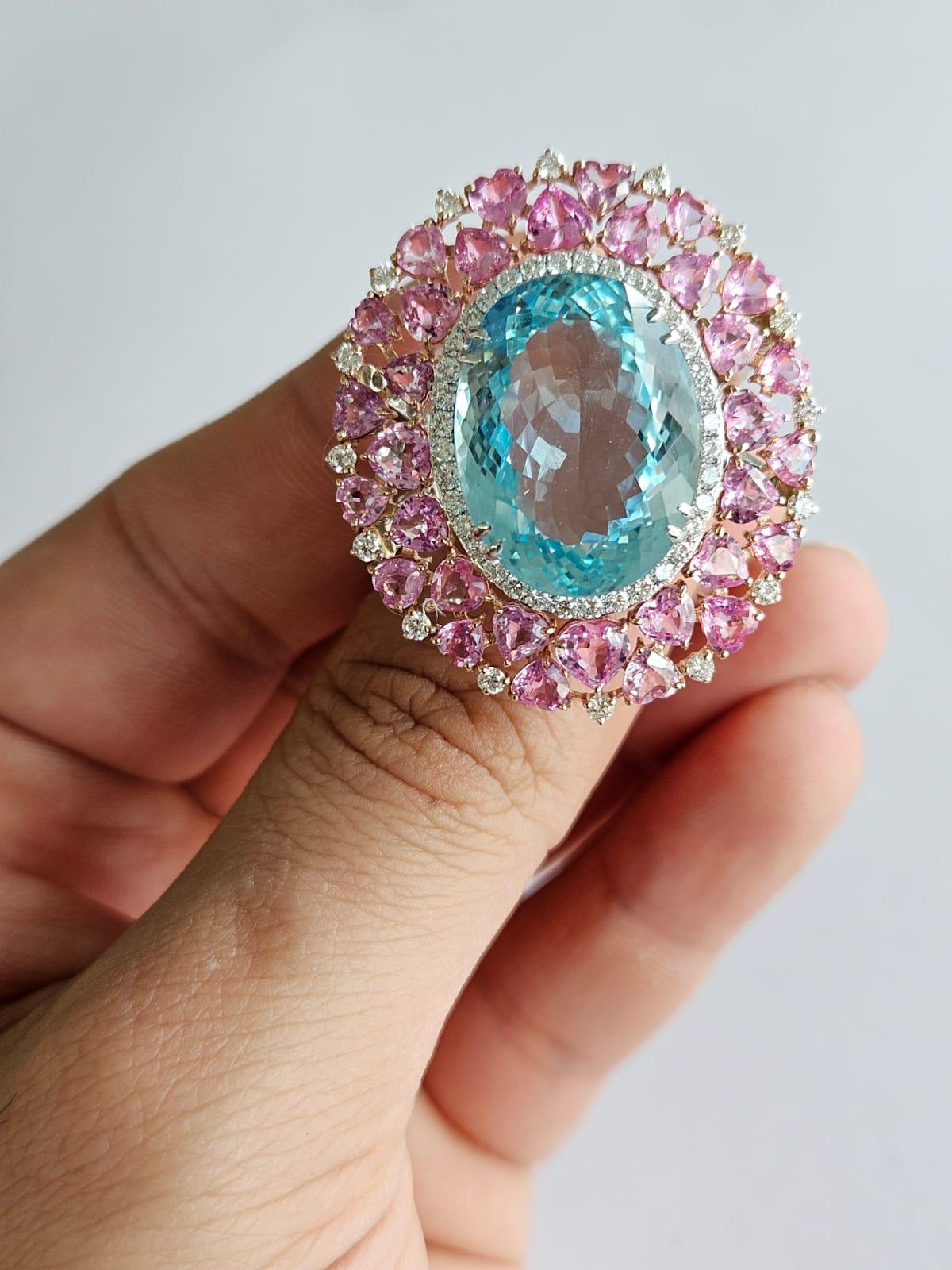 A very gorgeous and beautiful, Aquamarine & Pink Sapphires Cocktail Ring set in 18K White Gold & Diamonds. The weight of the Aquamarine is 19.58 carats. The Pink Sapphires weight is 7.24 carats. The heart shaped Pink Sapphires are of Ceylon (Sri