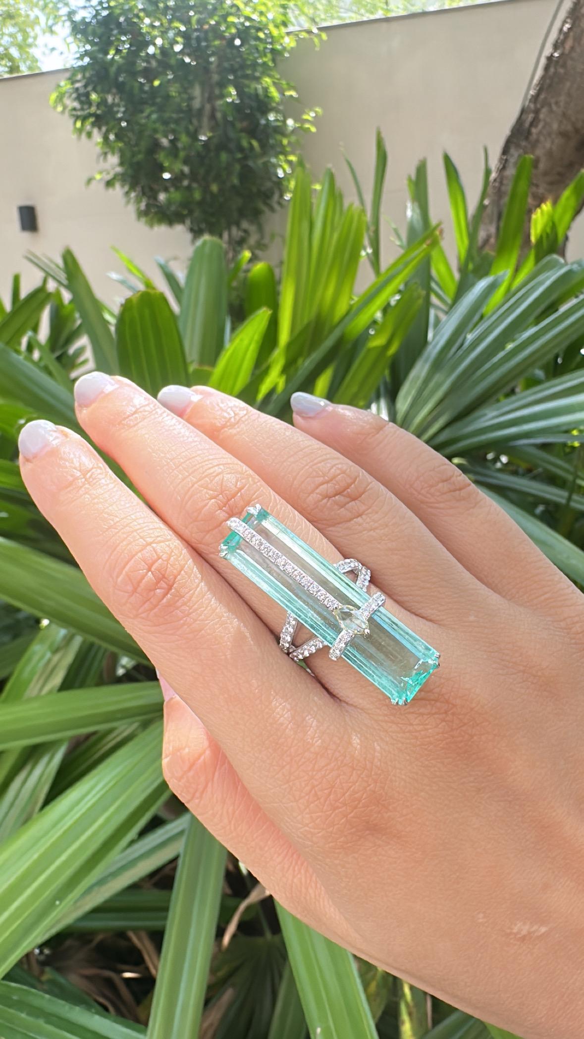 A very gorgeous and beautiful, Emerald Cocktail Ring set in 18K White Gold & natural Diamonds. The weight of the Emerald is 20.81 carats. The Emerald is completely natural, without any treatment and is of origin. The combined Diamonds weight is 1.49