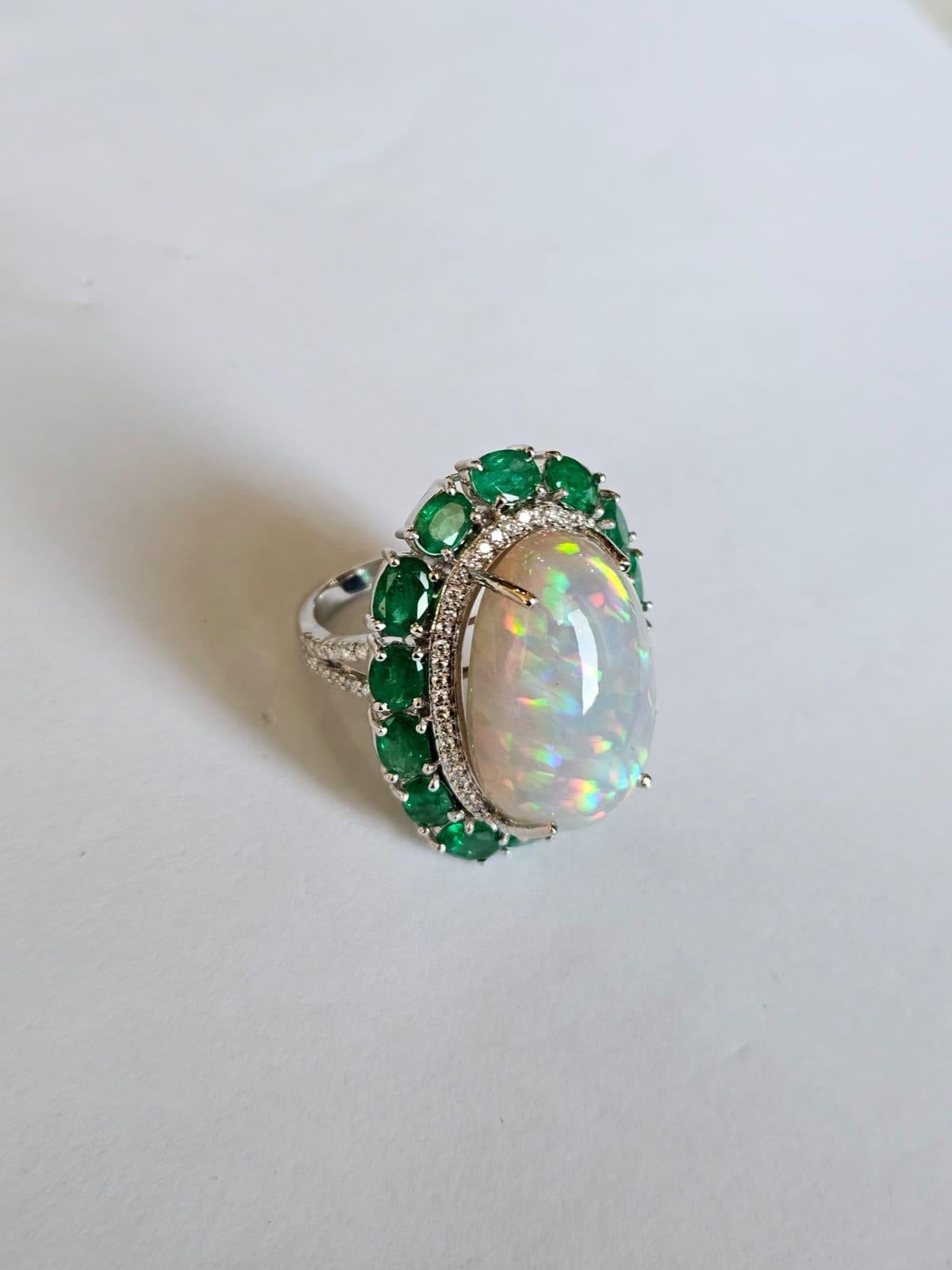 Oval Cut Set in 18K Gold, 21.06 carats Ethiopian Opal, Emeralds & Diamonds Cocktail Ring For Sale