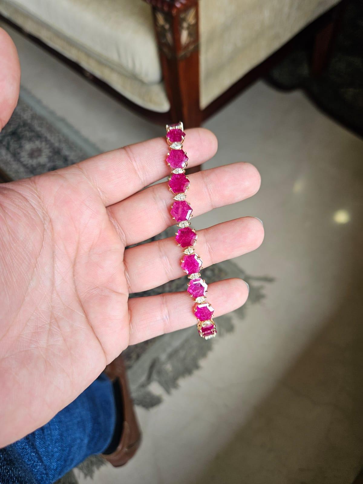 A very beautiful and gorgeous, modern style, Ruby Bracelet set in 18K Yellow Gold & Diamonds. The weight of the Hexagon shaped Ruby is 21.83 carats. The Rubies are completely natural, without any treatment and is of Mozambique origin. The Diamonds