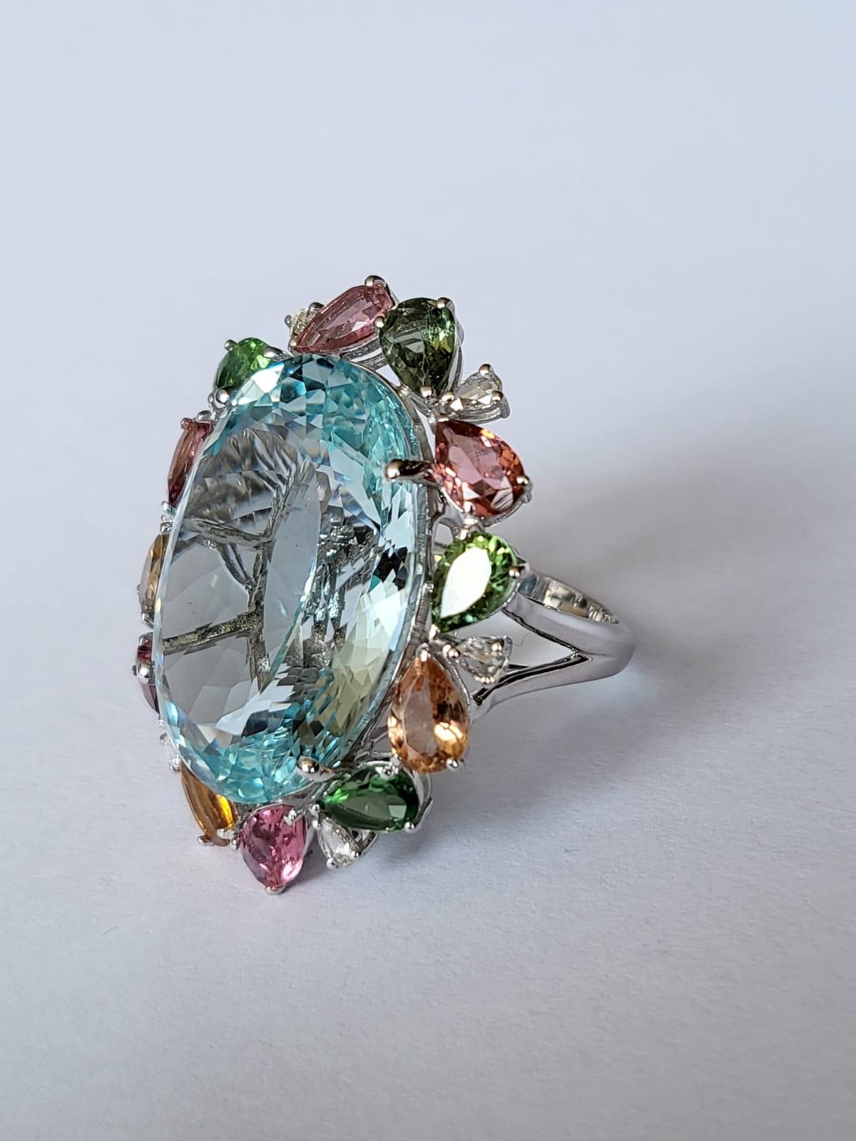 Oval Cut set in 18K Gold, 24.67 carats, Aquamarine, Tourmaline & Diamonds Cocktail Ring For Sale