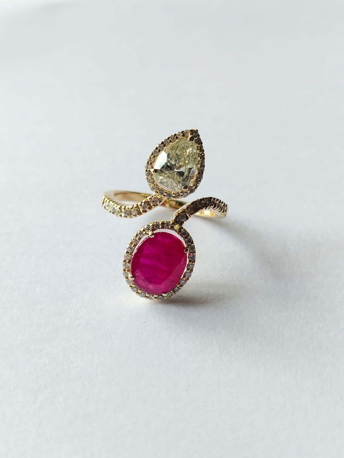 A very gorgeous and beautiful, Ruby Engagement Ring set in 18K Gold & Diamonds. The weight of the Ruby is  2.76 carats. The oval Ruby is completely natural, without any treatment and is of Mozambique origin. The pear shaped diamond weight is 0.93