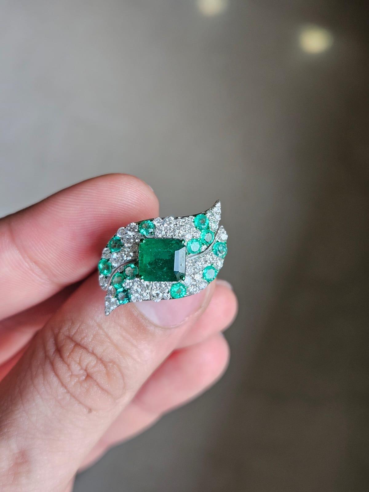 A very gorgeous and stunning, modern style, Emerald Cocktail Ring set in 18K White Gold & Diamonds. The combined weight of the Emeralds is 2.85 carats. The Emeralds are completely natural, without any treatment and are of Zambian origin. The