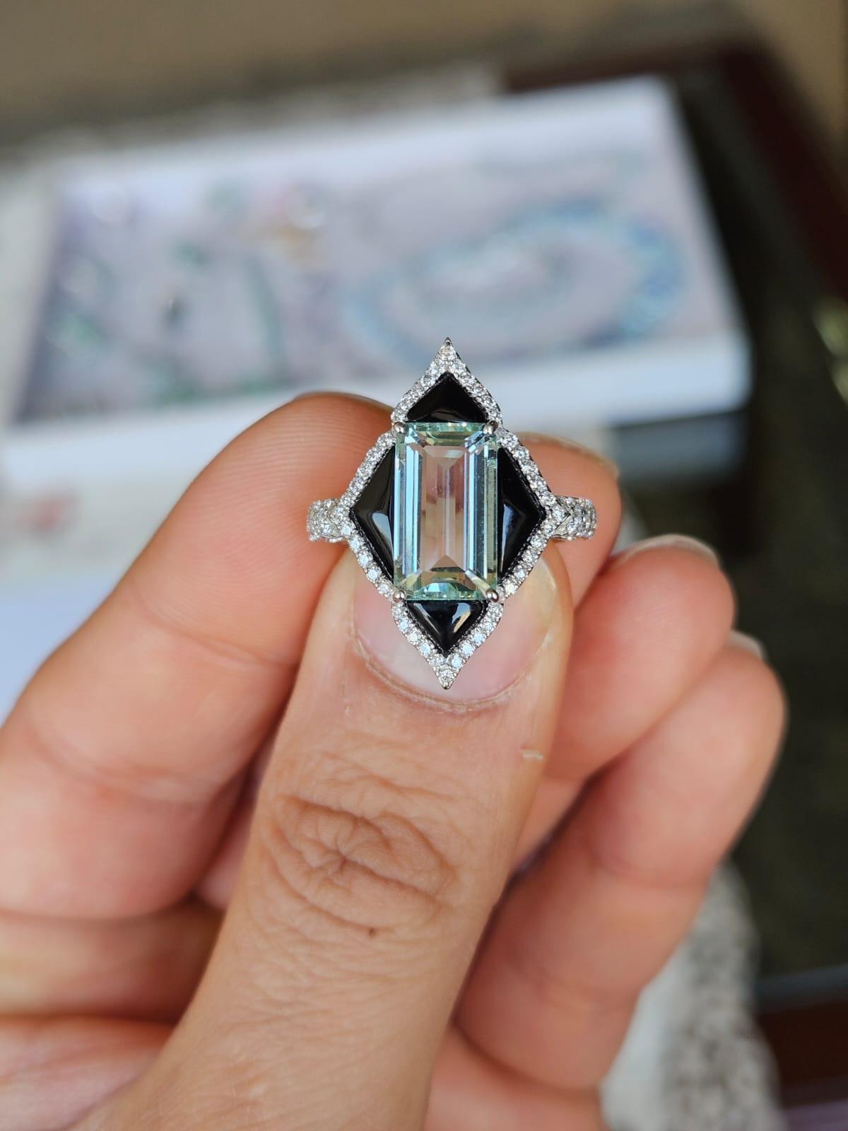 A very gorgeous and beautiful, modern style, Aquamarine & Black Onyx Engagement Ring set in 18K White Gold & natural Diamonds. The weight of the Aquamarine is 3.45 carats. The weight of the custom cut Black Onyx is 1.52 carats. The Diamonds weight