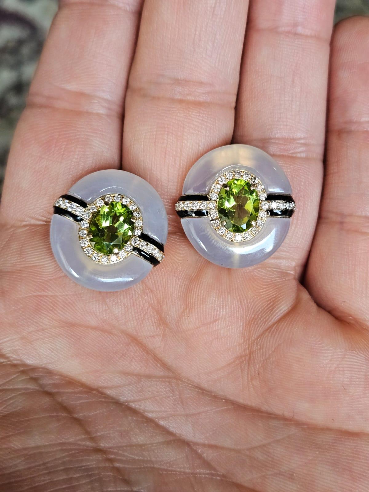 A very gorgeous and beautiful, Art Deco style, Peridot, Calcedony  & Black Onyx Stud Earrings set in 18K Yellow Gold & Diamonds. The weight of the Oval shaped Peridot is 3.55 carats. The weight of the Chalcedony is 14.99 carats. The Chalcedony is