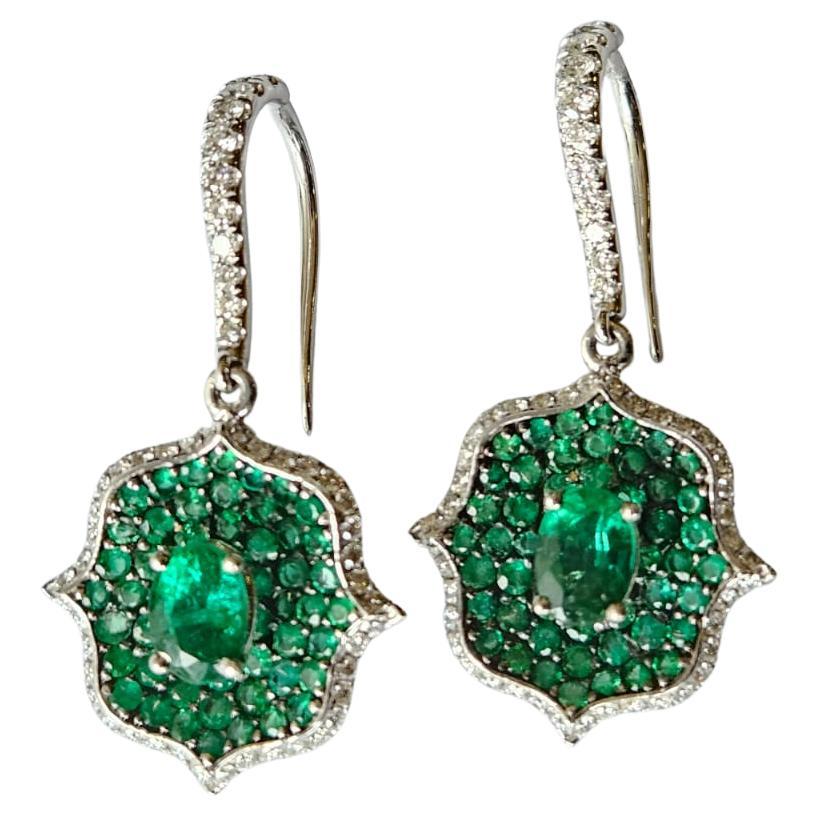 A very beautiful and unique, Emerald Dangle Earrings set in 18K White Gold & natural Diamonds. The combined weight of the Emeralds is 3.57 carats. The Emeralds are completely natural, without any treatment & is of Zambian origin. The Diamonds weight