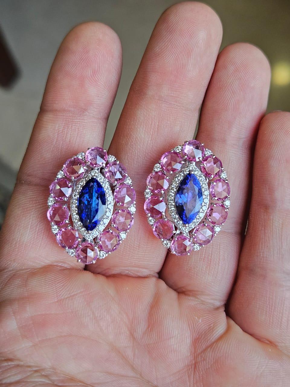 A very gorgeous and beautiful, modern style, Tanzanite & Pink Sapphire Stud Earrings set in 18K White Gold & Diamonds. The weight of the marquise shaped Tanzanites is 3.66 carats. The Tanzanites are responsibly sourced from Tanzania. The weight of