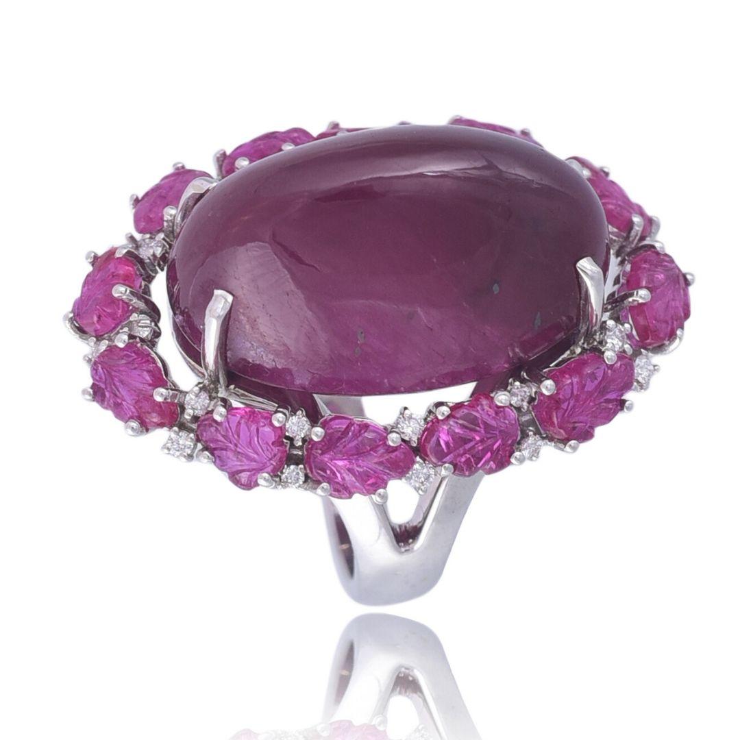 A gorgeous Cabochon and Carved Ruby Cocktail Ring set in 18K gold & Diamonds. The Rubies are completely natural, without any treatment and originates from Mozambique. The combined weight of the Rubies is 36.67 carats. The weight of the diamonds is