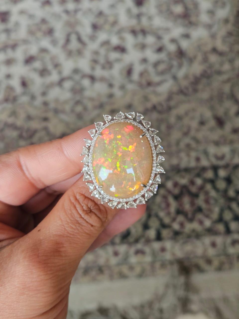 A very gorgeous and modern, Ethiopian Opal Cocktail Ring set in 18K White Gold & natural Diamonds. The weight of the Opal is 37.17 carats. The Opal is of Ethiopian origin and has a red - orange play of colour. The combined Diamonds weight is 2.39