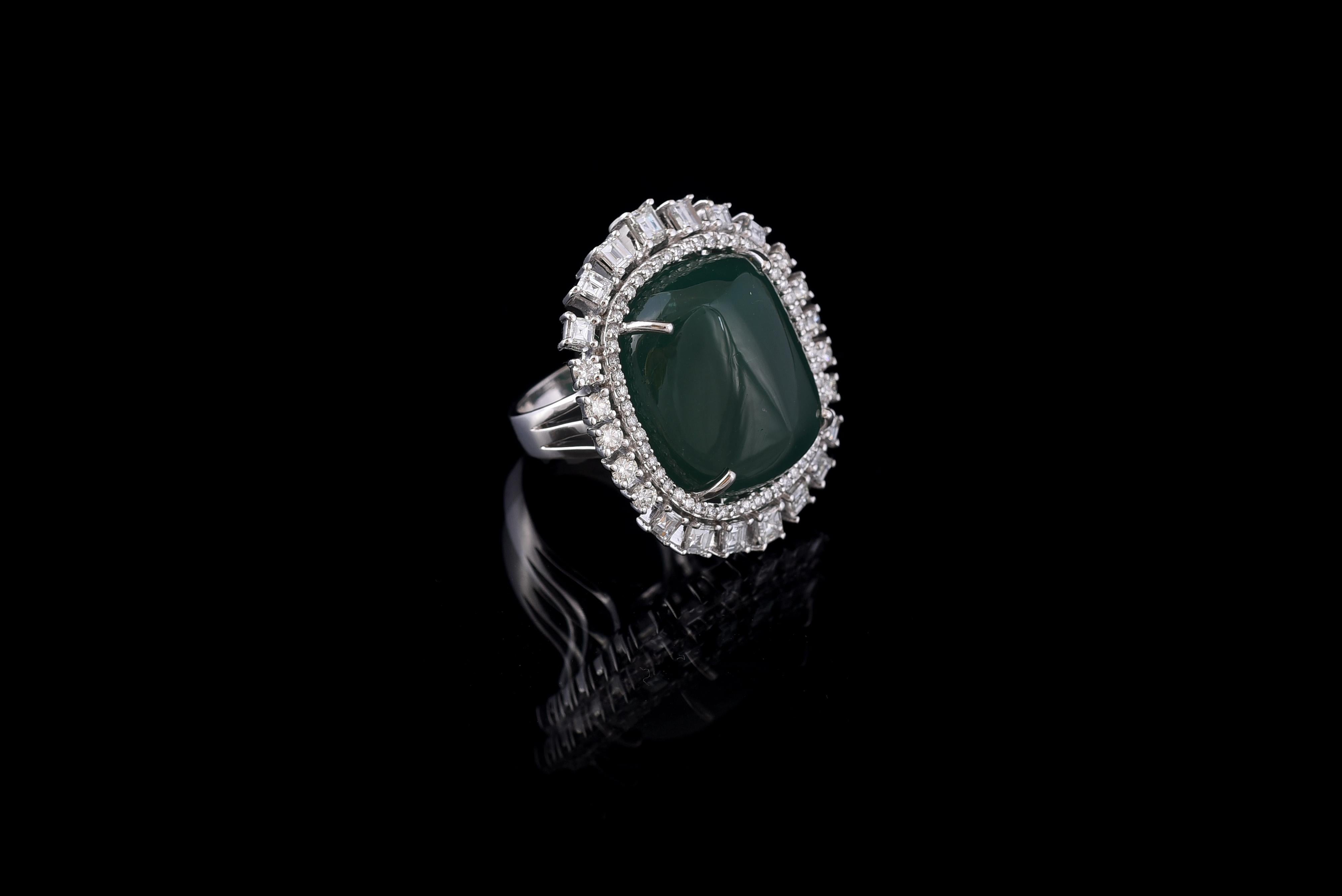 A gorgeous Emerald Cabochon and Princess diamonds Cocktail Ring set in 18K white gold. The Emerald is natural, without any treatment and originates from Zambia. The weight of the Emerald is 38.25 carats. The weight of the diamonds is 2.54 carats.