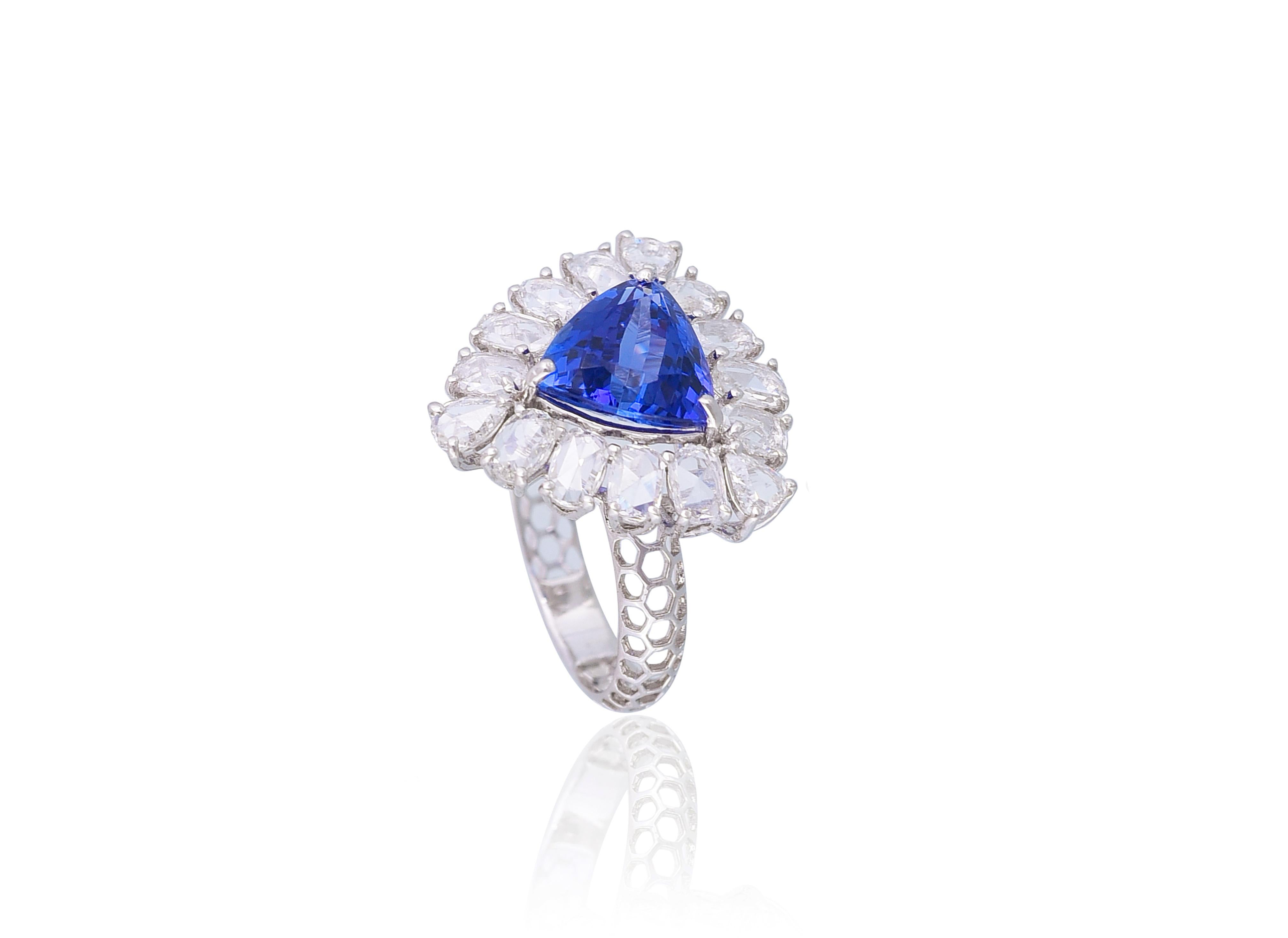 A very gorgeous and wearing Tanzanite and Diamonds Cocktail Ring set in 18K White Gold. The weight of the Tanzanite is 3.92 carats. The gorgeous Tanzanite has a Trillion Shape, is eye clean, is completely natural without any treatment and originates