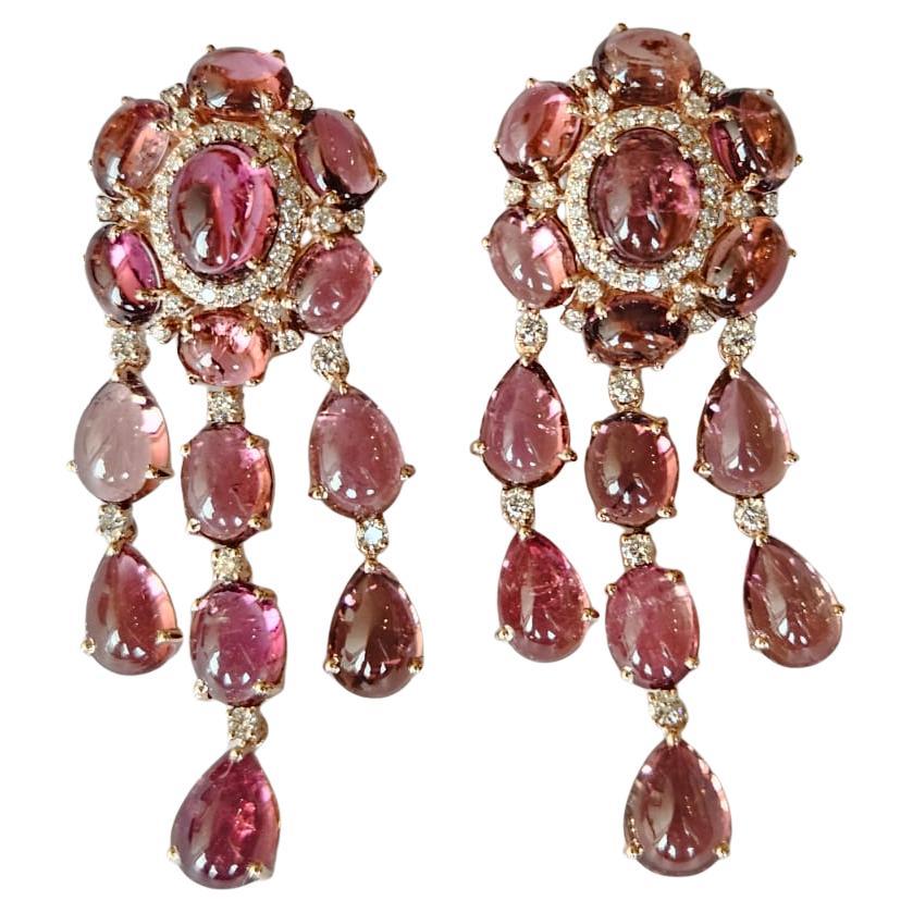 A very gorgeous and beautiful, Tourmaline Dangle Earrings set in 18K Rose Gold & natural Diamonds. The weight of the Tourmaline Cabochons is 39.21 carats. The Diamonds weight is 1.15 carats. Net 18K Gold weight is 14.35 grams. The Gross weight of