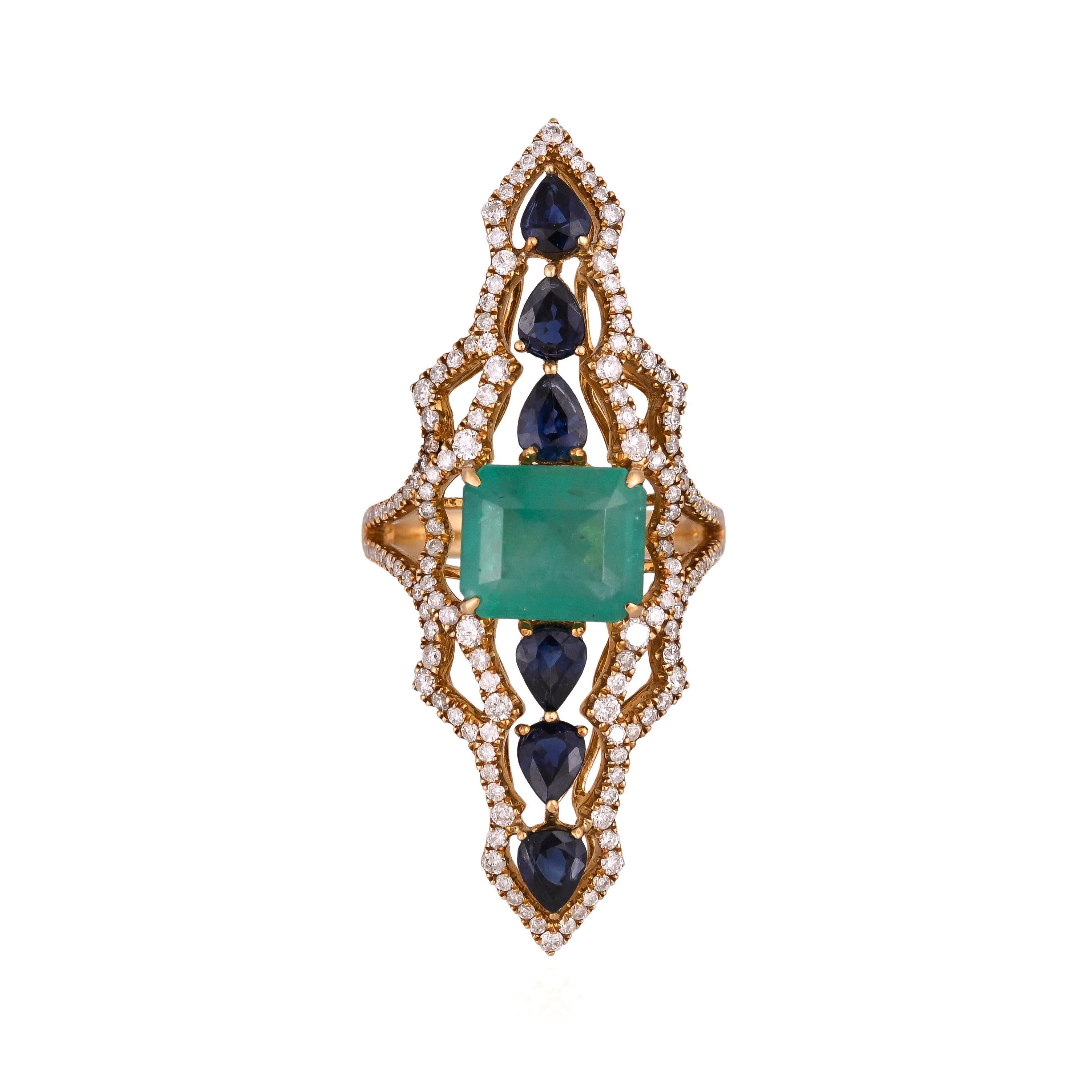 A very gorgeous and beautiful, modern style, Emerald & Blue Sapphires Cocktail Ring set in 18K Yellow Gold & natural Diamonds. The weight of the Emerald is 3.99 carats. The Emerald is completely natural, without any treatment and is of Colombian
