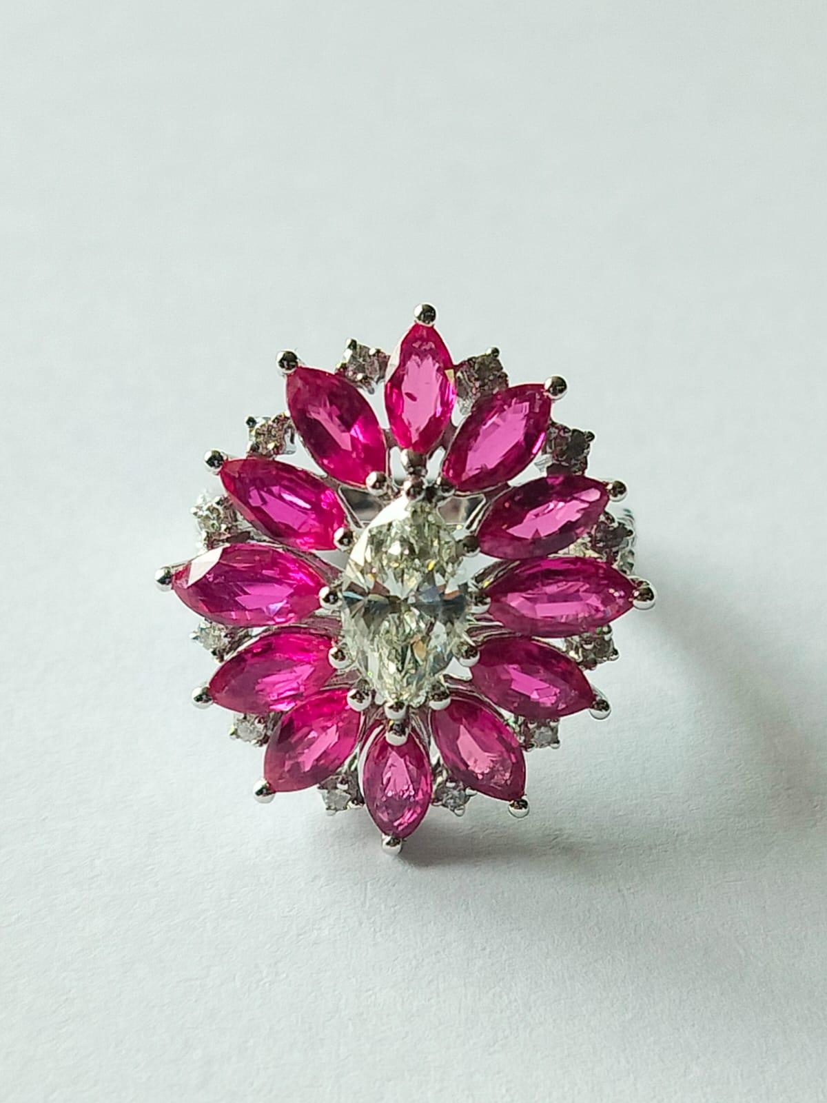 A classic Modern style Ruby Cocktail/Engagement Ring set in 18K Gold & Diamonds. The weight of the Ruby is 4.11 carats. The Marquise Ruby is completely natural, without any treatment and is of Mozambique origin. The combined weight of the diamonds