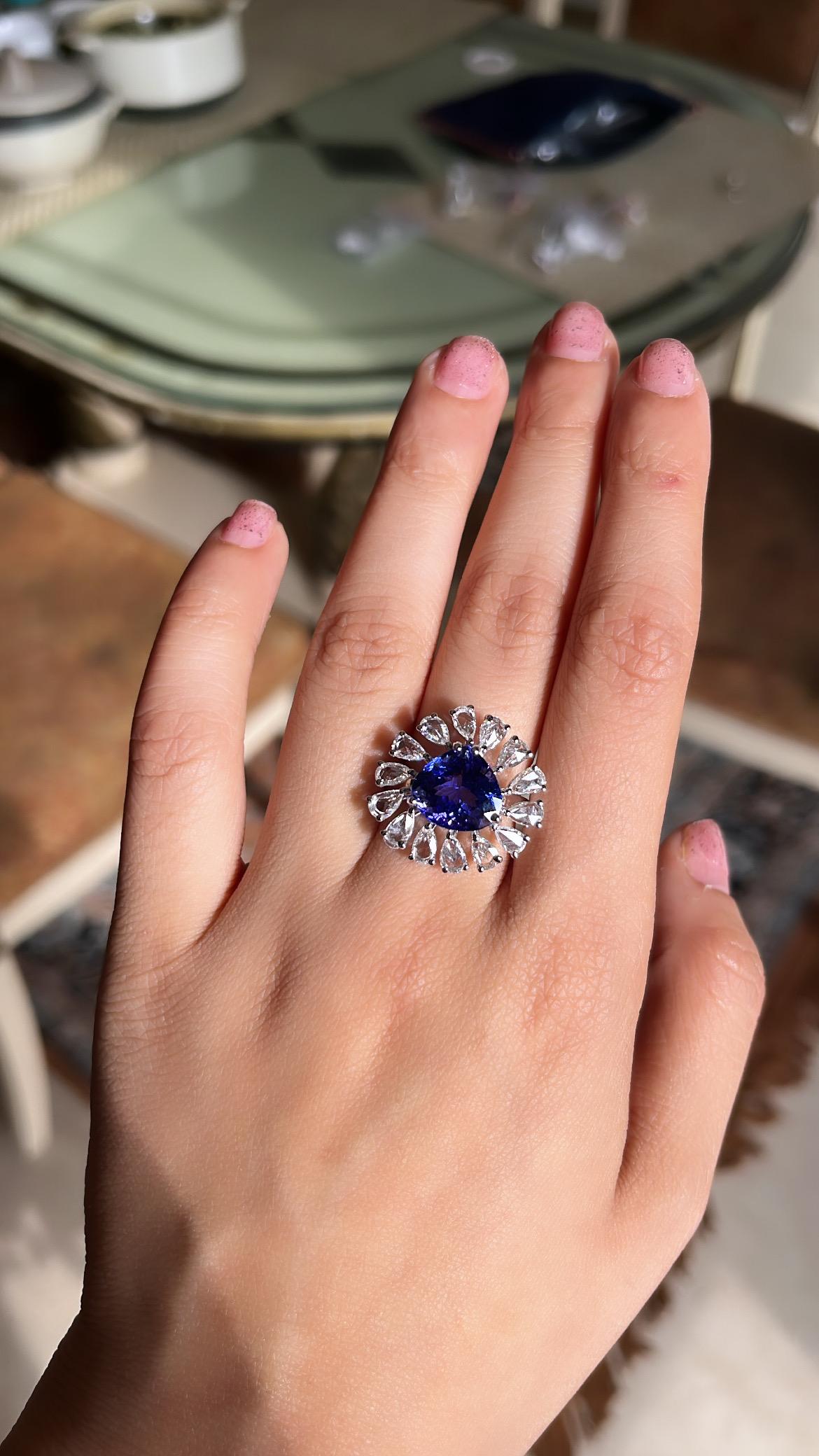 A very gorgeous and one of a kind, Tanzanite Cocktail/ Engagement Ring set in 18K White Gold & Diamonds. The weight of the Tanzanite is 5.48 carats. The Tanzanite is responsibly sourced from Tanzania and is free of any conflict. The weight of the