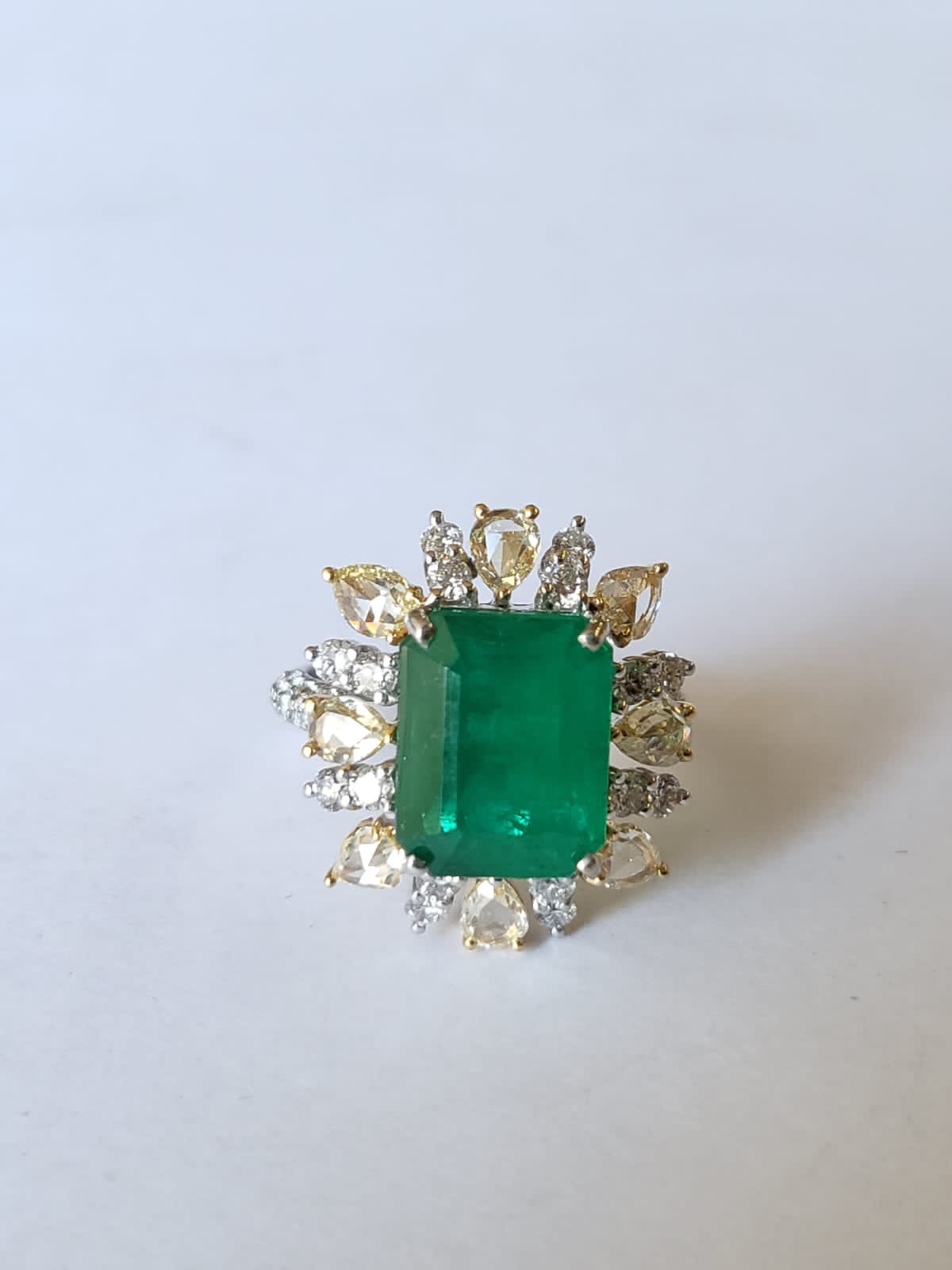 A very gorgeous and beautiful, Emerald Engagement Ring set in 18K White Gold & Diamonds. The weight of the Emerald is 5.52 carats. The Emerald is completely natural, without any treatment and is of Zambian origin. The weight of the Rose Cut Diamonds