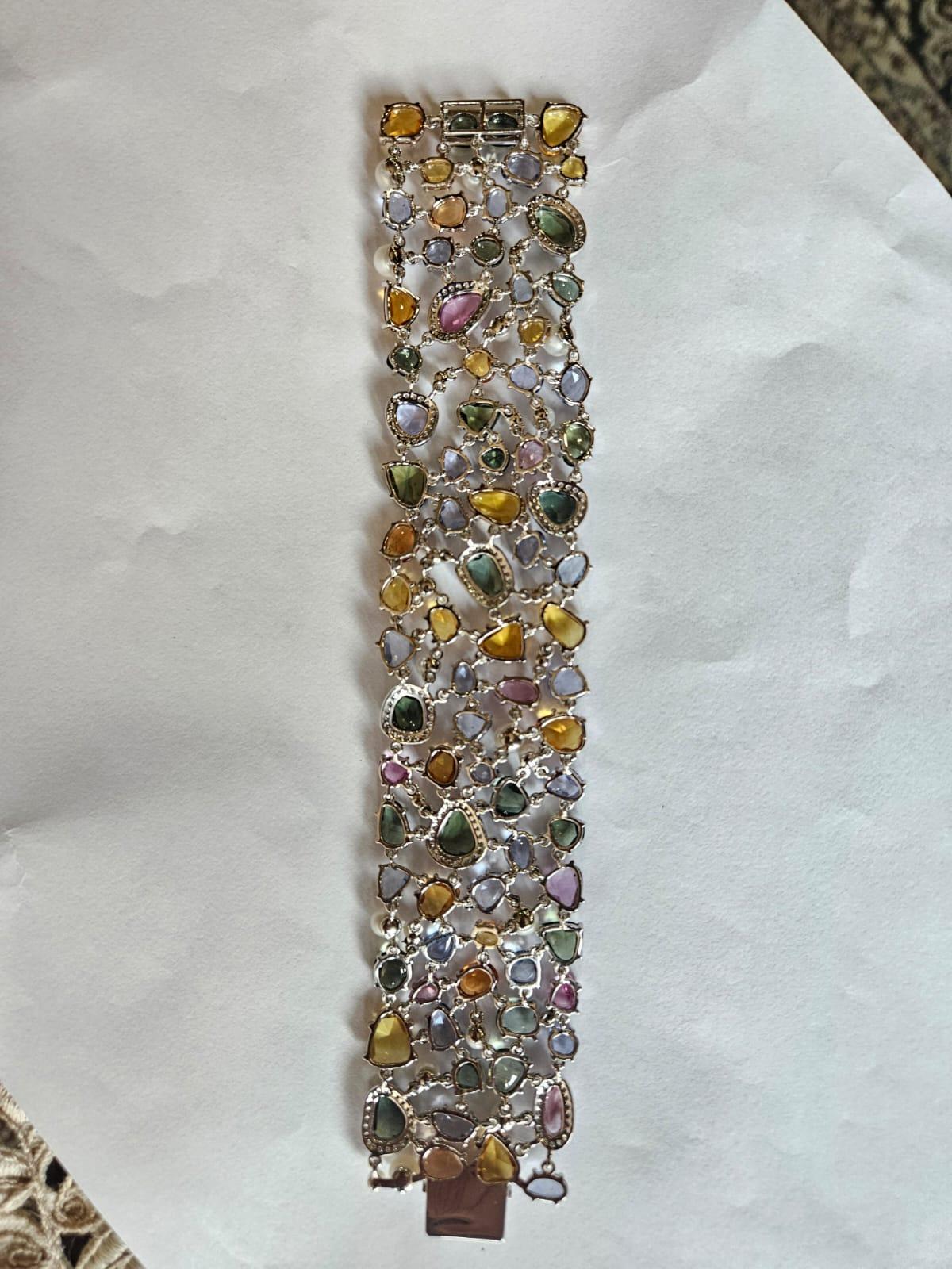 Un très beau et étonnant bracelet à maillons en or blanc 18 carats et diamants naturels, composé de plusieurs saphirs et de perles, unique en son genre. Le poids des saphirs multiples est de 68.39 carats. Les saphirs multiples sont originaires de