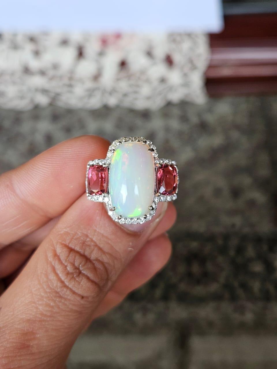 A very gorgeous and beautiful, Opal & Rubellite Cocktail Ring set in 18K White Gold & natural Diamonds. The weight of the Ethiopian Opal is 6.99 carats. The weight of the Rubellite is 2.00 carats. The Diamonds weight is 0.62 carats. Net 18K White