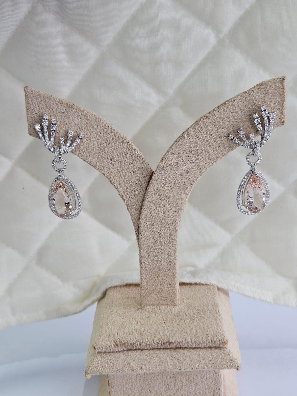 A very gorgeous and special, modern style, Morganite Drop Earrings set in 18K White Gold & Diamonds. The weight of the pear shaped Morganites is 7.40 carats. The Diamonds weight is 1.64. carats. Net 18K White Gold weight is 6.18 grams. The Gross