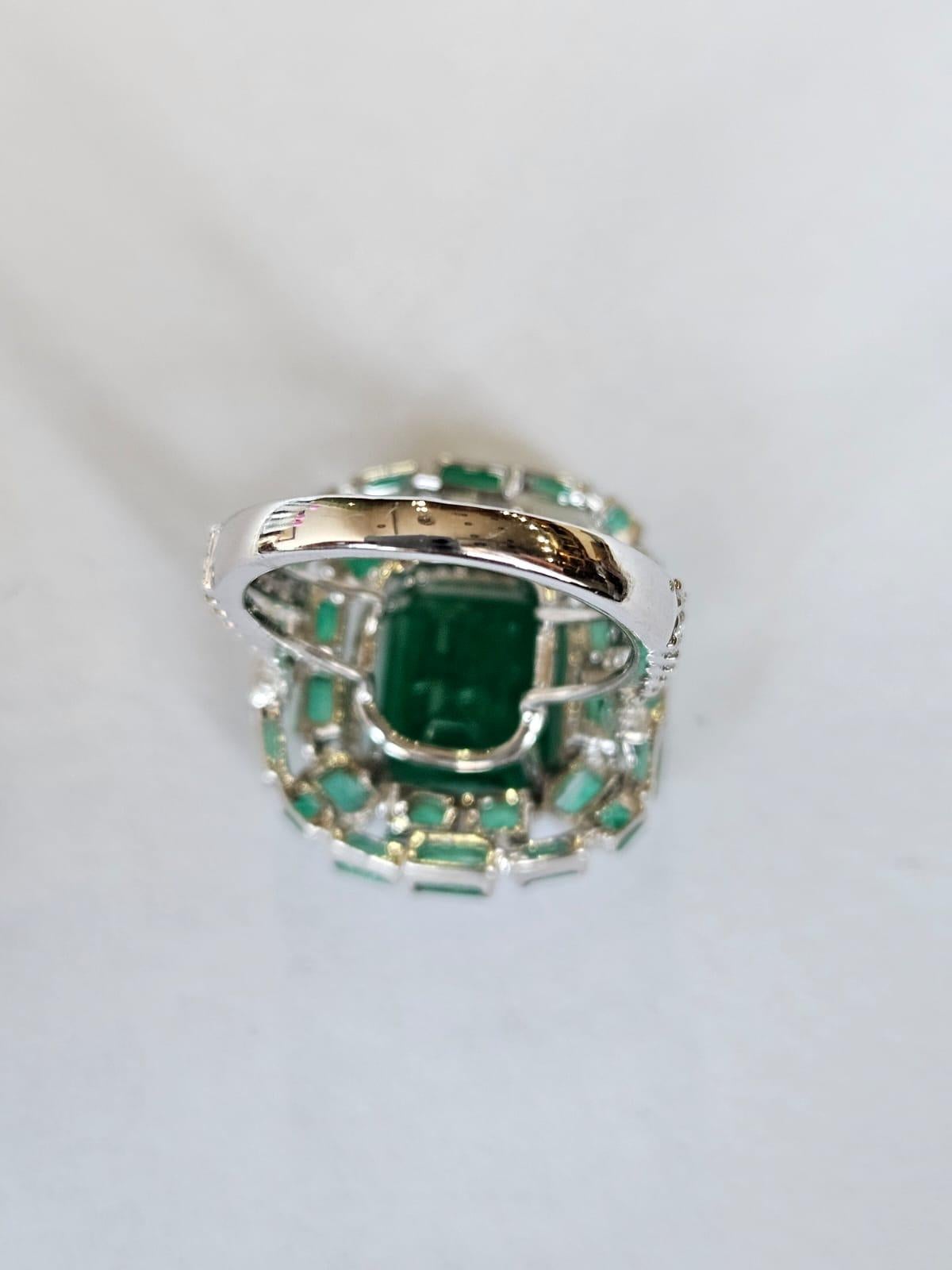 A very gorgeous and beautiful, modern style, Emerald Engagement Ring set in 18K White Gold & natural Diamonds. The combined weight of the Emeralds is 7.59 carats. The Emeralds are completely natural, without any treatment and are of Zambian origin.