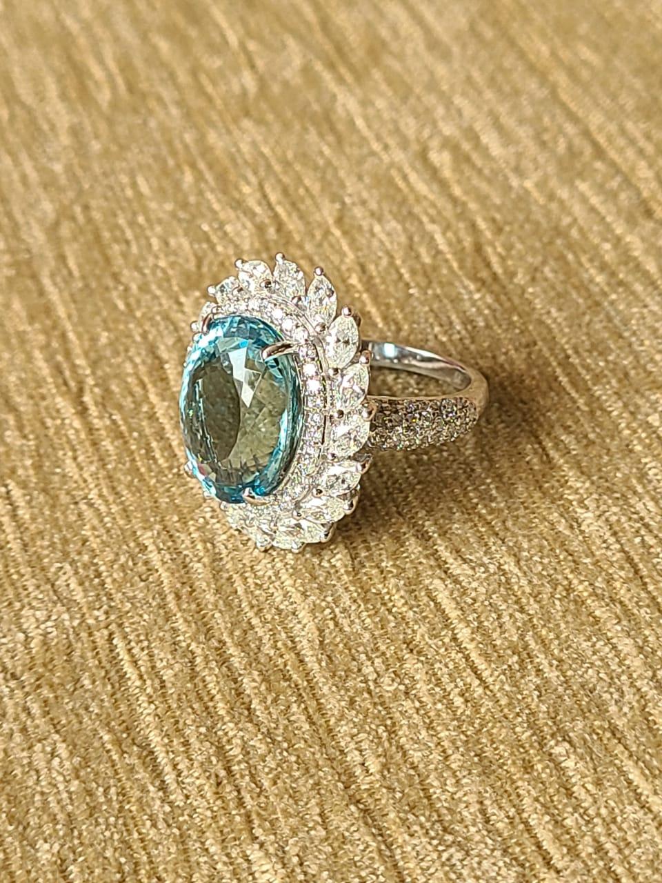 A very gorgeous and one of a kind Aquamarine Cocktail/ Engagement ring set in 18K Gold & Diamonds. The weight of the Aquamarine is 8.56 carats. The combined weight of the Diamonds is 2.37 carats. Net Gold weight is 8.86 grams. The dimensions of the