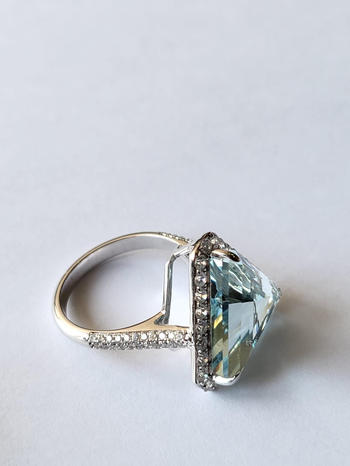 A very gorgeous and one of a kind, Aquamarine Engagement / Cocktail Ring set in 18K White Gold & Diamonds. The weight of the Trillion shaped Aquamarine is 8.90 carats. The weight of the Diamonds is 1.05 carats. Net Gold weight is 5.54 grams. The