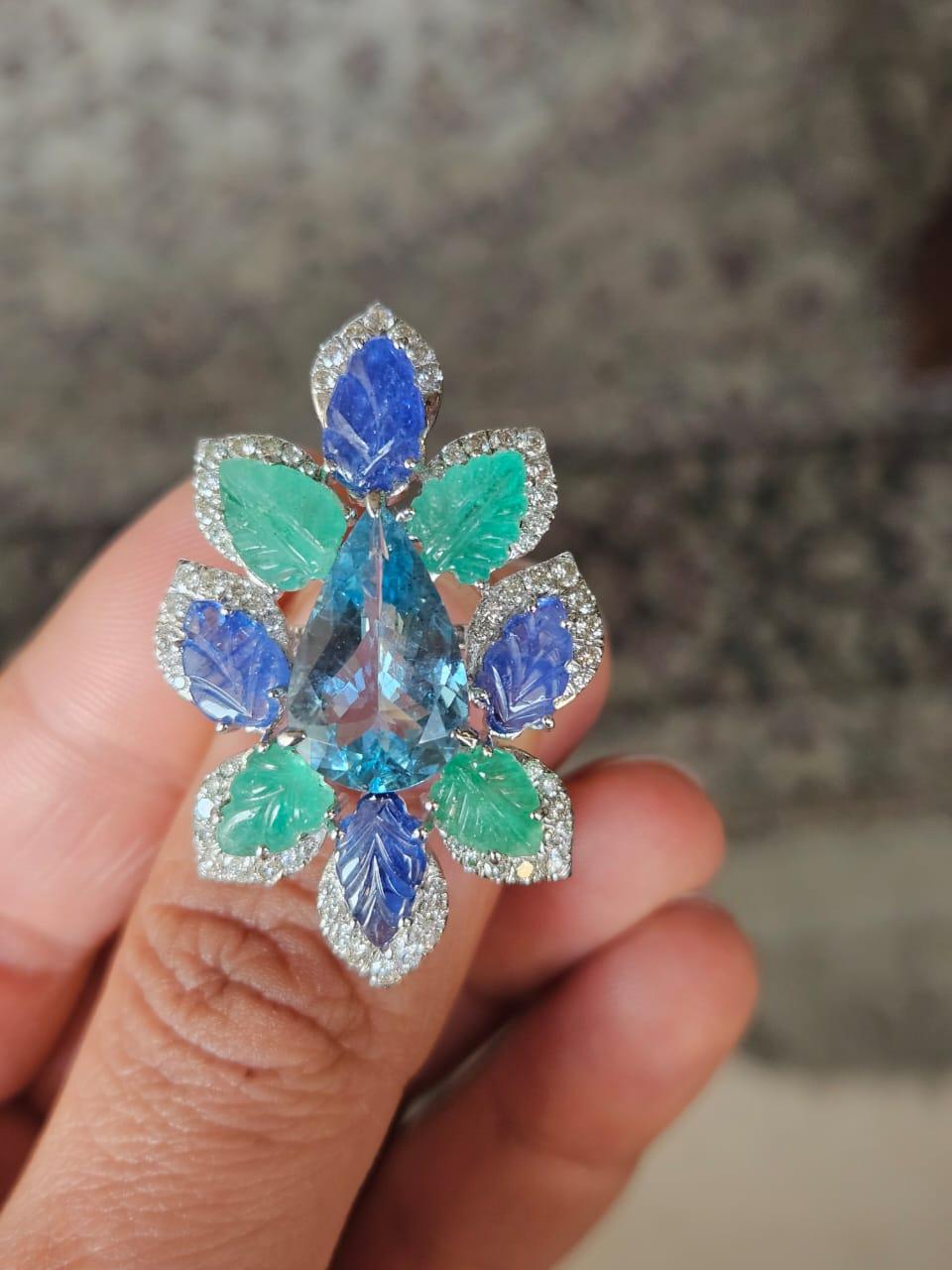 A very gorgeous and beautiful, Aquamarine, Blue Sapphires & Emeralds Cocktail Ring set in 18K White Gold & natural Diamonds. The weight of the Aquamarine is 4.00 carats. The combined weight of Blue Sapphires & Emeralds is 7.63 carats. The Blue