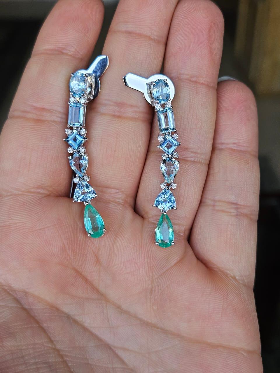 A very gorgeous and modern style, Aquamarine & Emerald Chandelier Earrings set in 18K White Gold & natural Diamonds. The weight of the Aquamarines is 24.57 carats. The Emeralds weight is 1.71 carats. The Emeralds are completely natural, without any