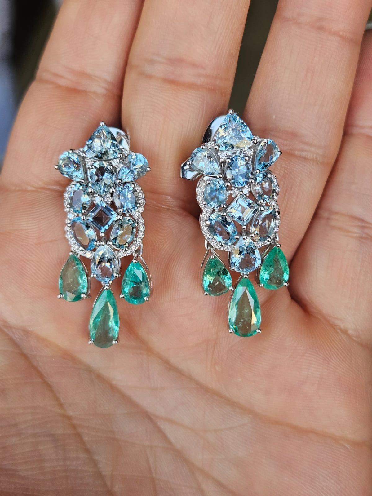 A very gorgeous and beautiful, modern style, Aquamarine & Emeralds Dangle Earrings set in 18K White Gold & natural Diamonds. The weight of the Aquamarines is 7.82 carats. The weight of the Emeralds is 5.16 carats. The Emeralds are completely
