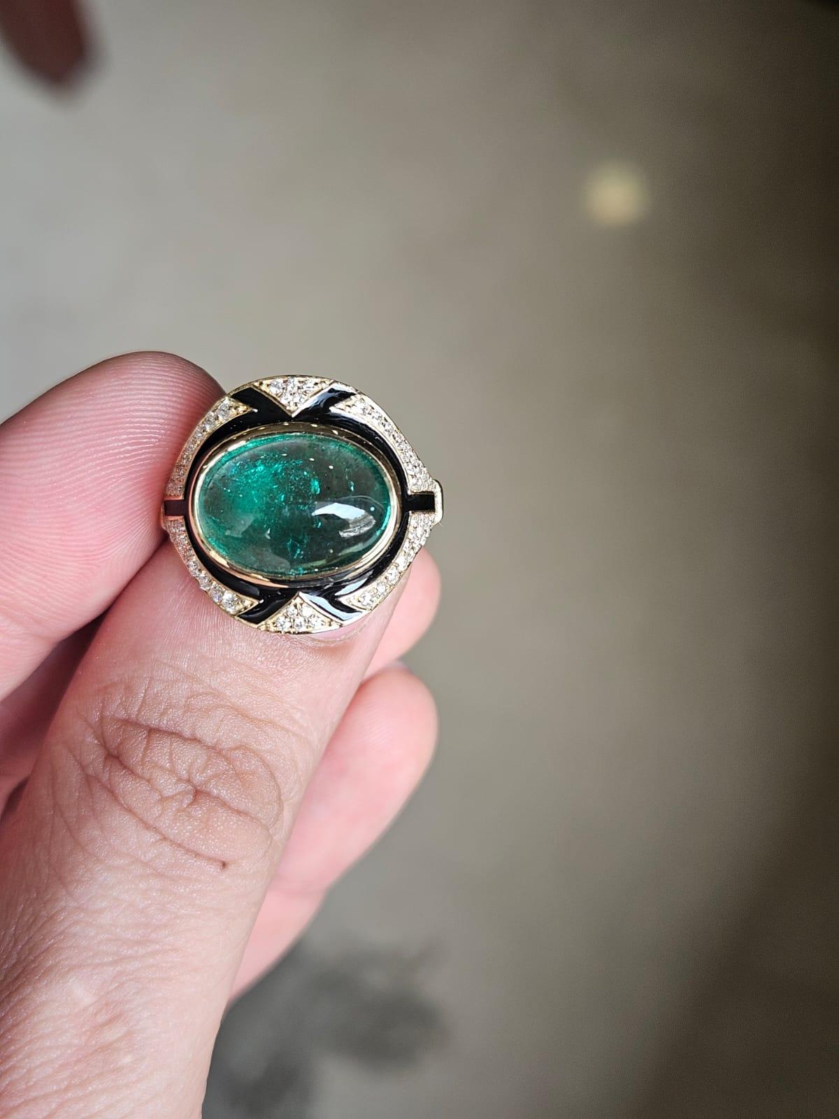A very gorgeous and beautiful, Art Deco style, Emerald & Black Enamel Engagement Ring set in 18K Yellow Gold & natural Diamonds. The weight of the Emerald cabochon is 6.44 carats. The Emerald is completely natural, without any treatment and is of