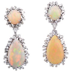 Set in 18K gold, Art Deco style Ethiopian Opal 
baguette diamond drop earrings