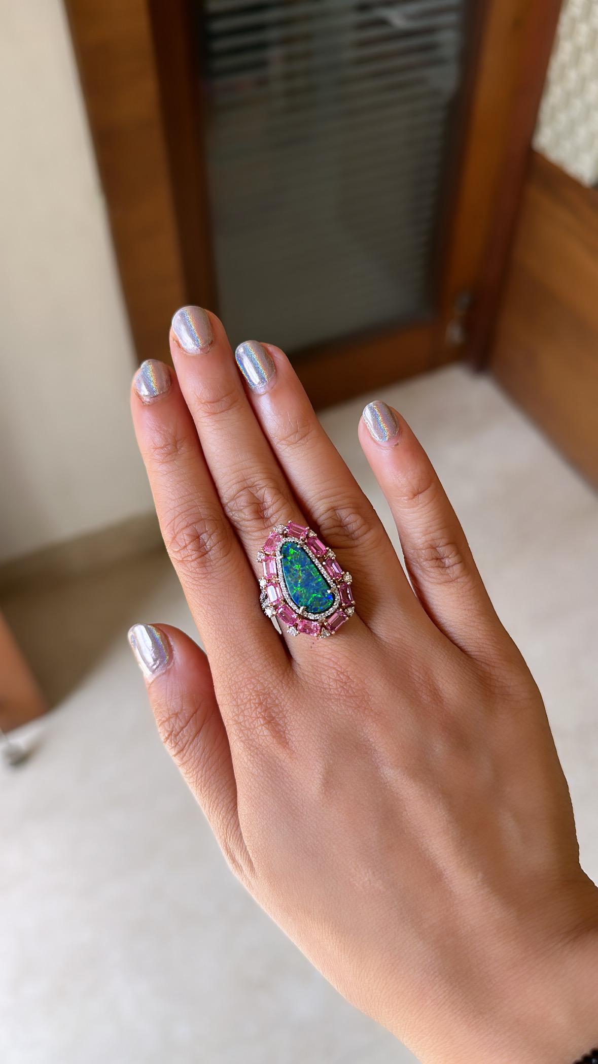A very gorgeous and modern, Doublet Opal & Pink Sapphires Cocktail Ring set in 18K White Gold & Diamonds. The weight of the Doublet Opal is 3.37 carats. The Opal is of Australian origin and has a gorgeous blue and green play of colour. The weight of