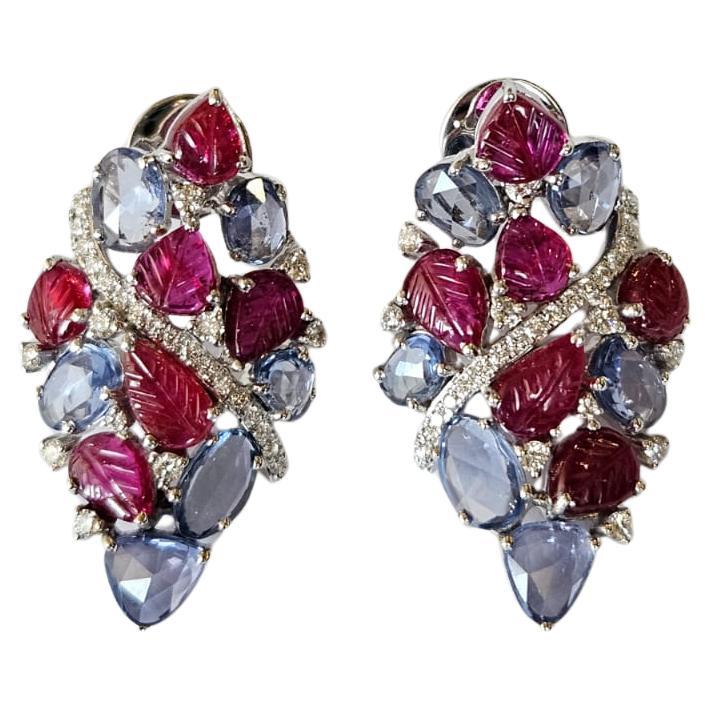 Set in 18K Gold, Blue Sapphires, carved Rubies & Diamonds Stud Earrings