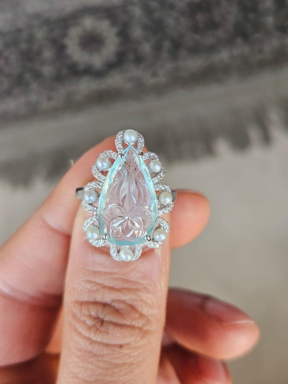 A very gorgeous and beautiful, Aquamarine & Freshwater Pearls Cocktail Engagement Ring set in 18K White Gold & natural Diamonds. The weight of the carved Aquamarine is 6.28 carats. The Aquamarine is hand - carved in our very own workshop. The weight