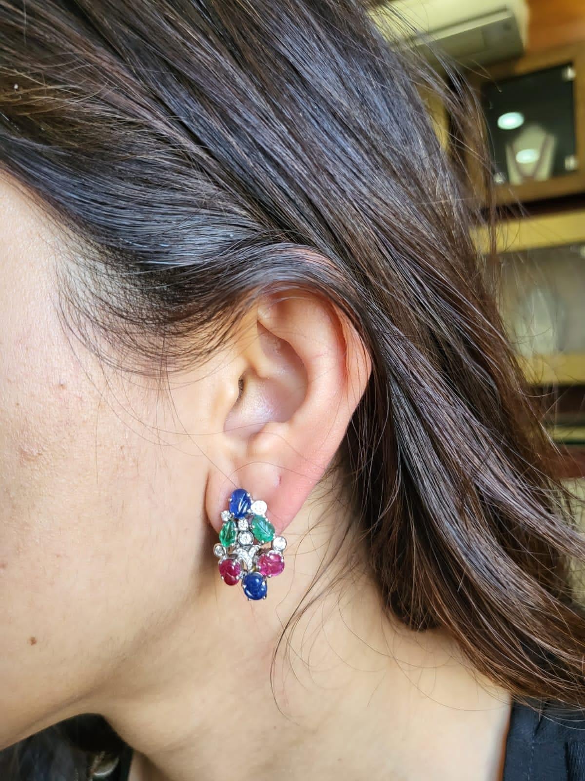A very cute and dainty pair of Tutti - Frutti Earrings set in 18K White Gold with Blue Sapphire, Emerald & Ruby & Diamonds. The weight of the coloured stones is 6.64 carats. The Blue Sapphire, Emerald & Ruby are completely natural, without any