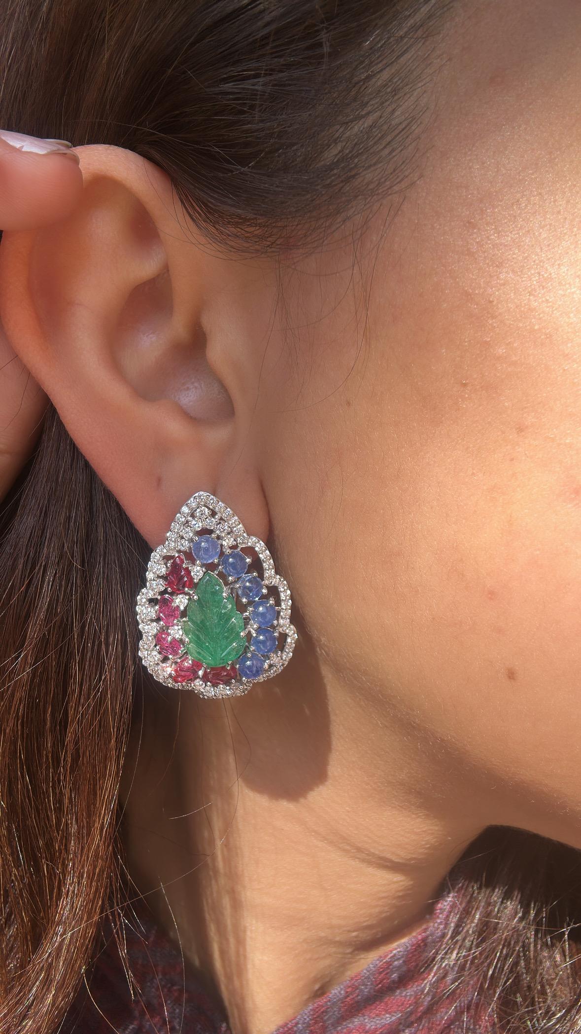 A very gorgeous and and beautiful, classical style, Emerald, Blue Sapphire & Ruby Stud Earrings set in 18K White Gold & natural Diamonds. The combined weight of the carved Emeralds, Blue Sapphires & Rubies is 12.85 carats. The Emerald is completely