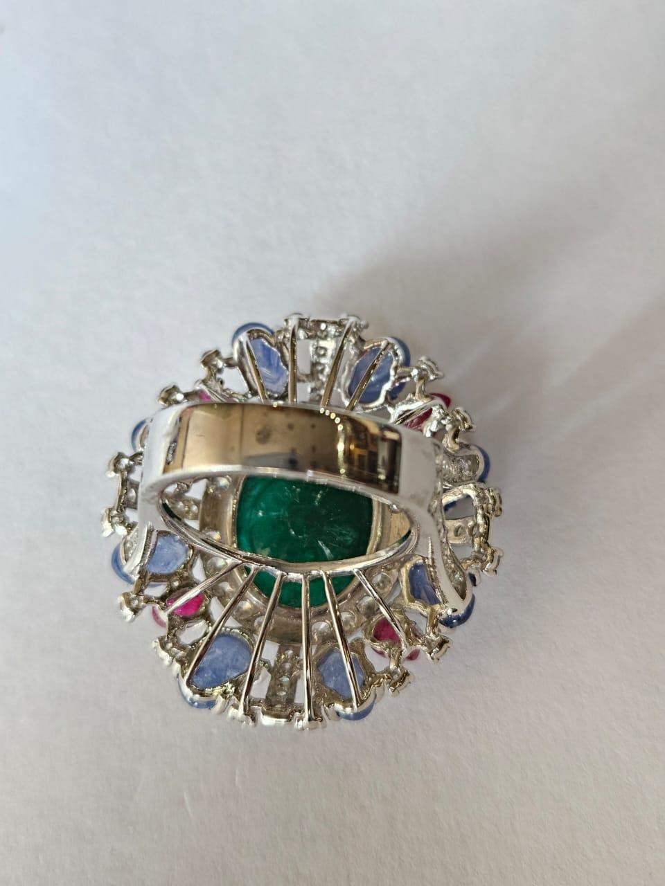 Art Deco Set in 18K Gold, carved Emerald, Blue Sapphires, Rubies & Diamonds Cocktail Ring For Sale