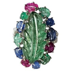 Set in 18K Gold, carved Emerald, Blue Sapphires, Ruby & Diamonds Cocktail Ring