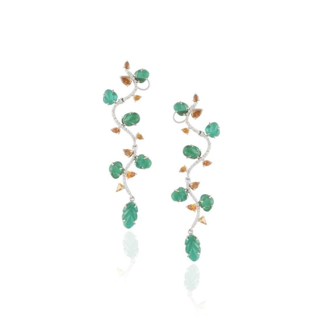 A gorgeous and very chic pair of carved Zambian Emerald & Coloured Diamonds Chandelier Earrings set in 18K Gold. The weight of the Emeralds is 13.95 carats. The Emeralds originate from Zambia and are hand-carved in our very own workshop. The