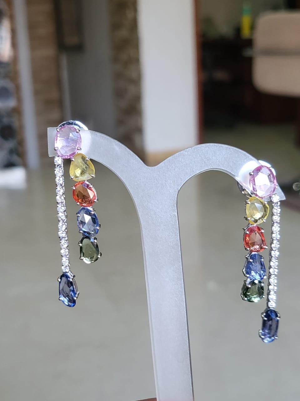 A very beautiful and chic Multi Sapphire Chandelier/ Dangle Earrings set in 18K White Gold & Diamonds. The weight of the Multi Sapphires is 10.11 carats. The Multi Sapphire Rose Cuts are of Ceylon (Sri Lanka) origin. The weight of the Diamonds is