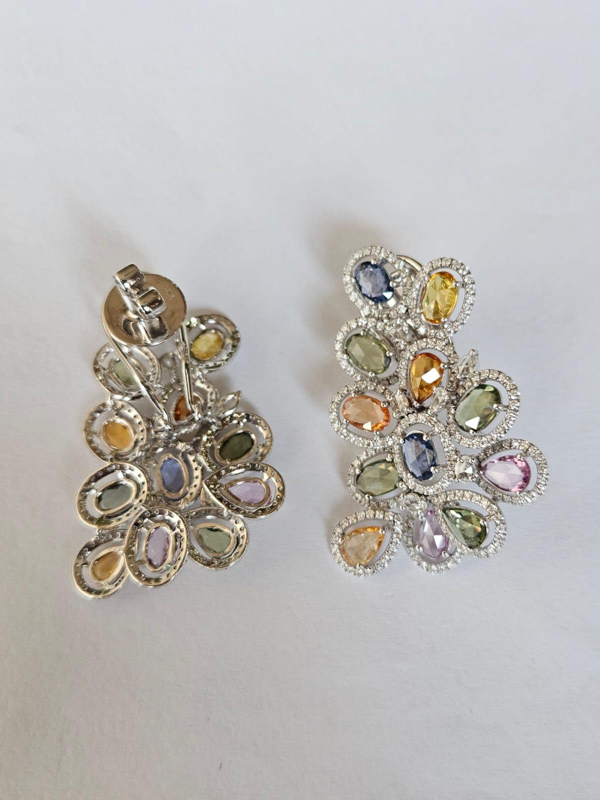 A very gorgeous and interesting, modern style, Multi Sapphires oversized Stud Earrings set in 18K White Gold & Diamonds. The weight of the Multi Sapphires is 9.64 carats. The Multi Sapphires are of Ceylon (Sri Lanka) origin. The combined Diamonds