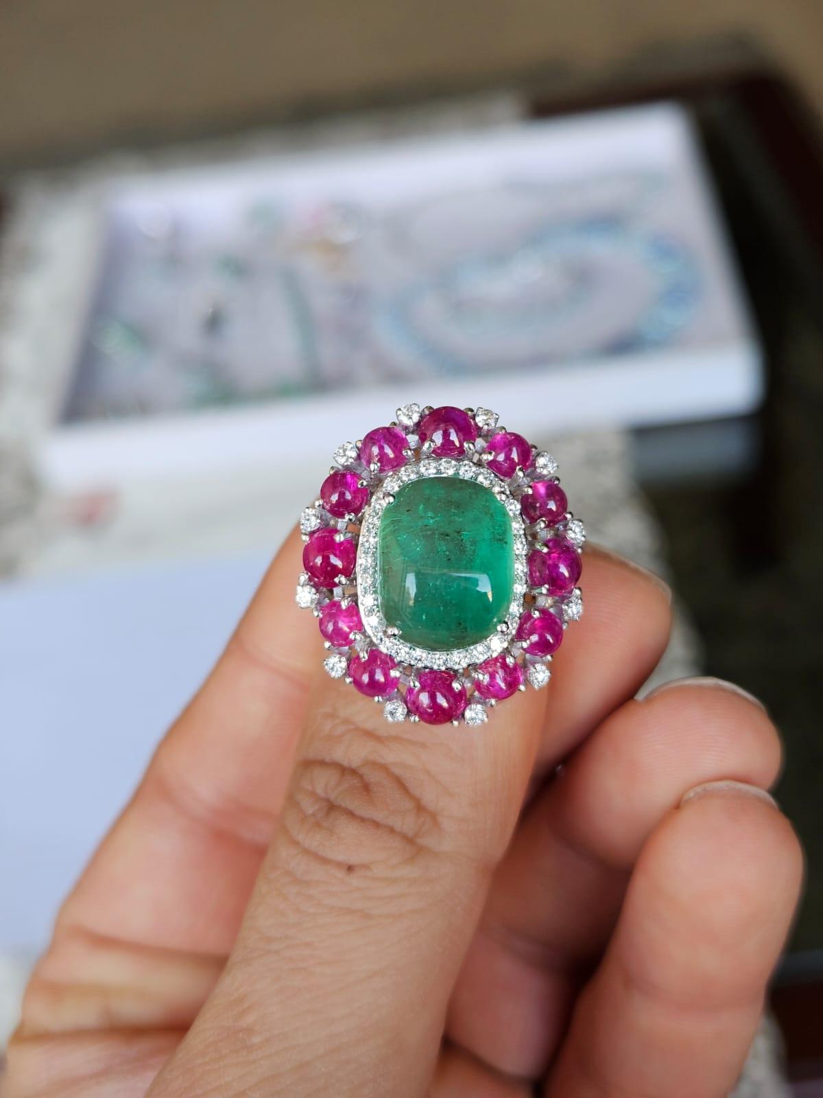 A very gorgeous and beautiful, Emerald & Ruby Cocktail Dome Ring set in 18K White Gold & natural Diamonds. The weight of the Emerald Cabochon is 9.75 carats. The Emerald is completely natural, without any treatment and is of Colombian origin. The