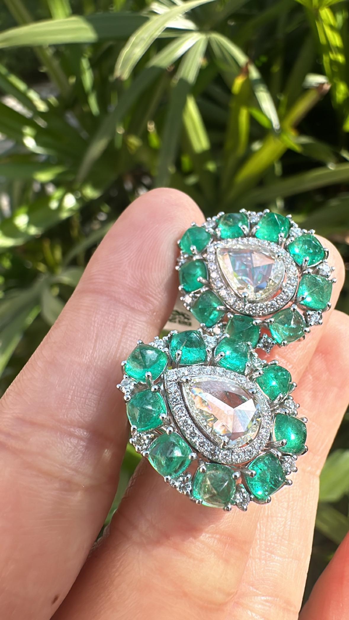 A very gorgeous and beautiful, modern style, Emerald Stud Earrings set in 18K White Gold & natural Diamonds. The weight of the Emerald Sugarloafs is 6.58 carats. The Emeralds are completely natural, without any treatment and is of Colombian origin.