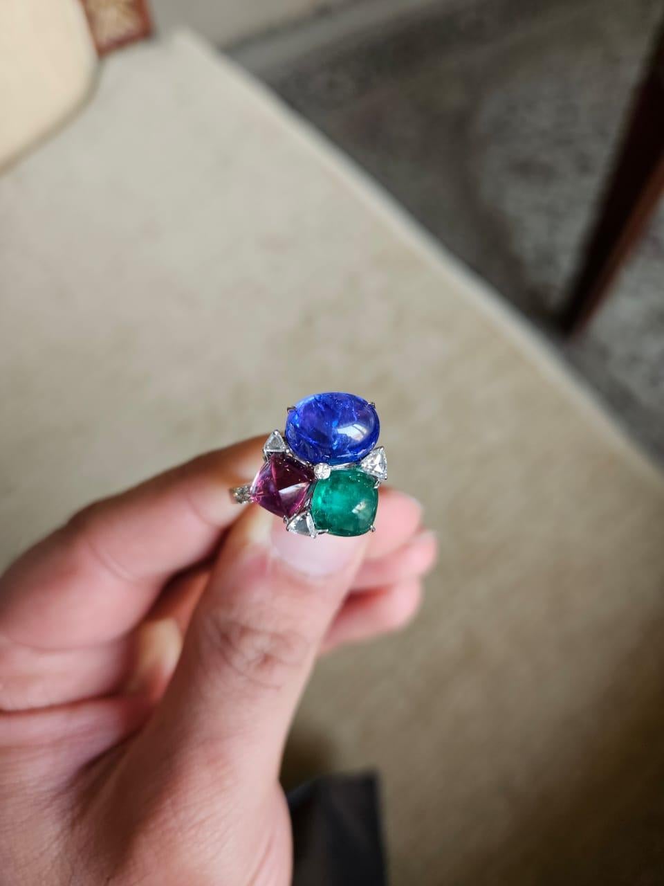 A very stunning & gorgeous, modern style, Emerald, Rubellite & Tanzanite Cocktail Ring set in 18K White Gold & Diamonds. The weight of the Emerald is 2.14 carats. The Emerald is completely natural, without any treatment and is of Zambian origin. The