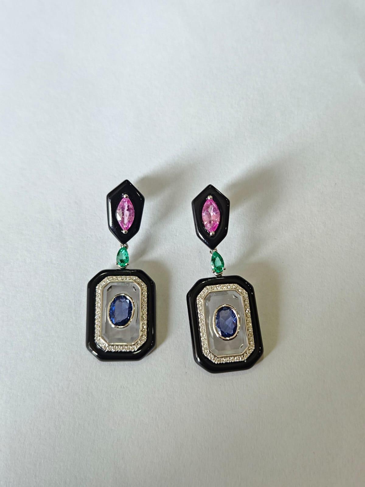 A very gorgeous and beautiful, Emeralds, Sapphires Black Onyx & Crystal Dangle Earrings set in 18K White Gold & natural Diamonds. The Emeralds weight is 0.32 carats. The Emeralds are completely natural, without any treatment and are of Zambian