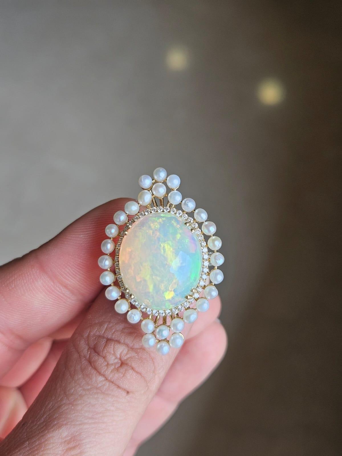 A very gorgeous and beautiful, Opal & Freshwater Pearls Cocktail Dome Ring set in 18K Gold & natural Diamonds. The weight of the Ethiopian Opal cabochon is 12.19 carats. The weight of the Freshwater Pearls is 3.80 carats. The Diamonds weight is 1.25